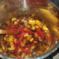 Mango chutney in pot 1 hour into cooking with darker colours
